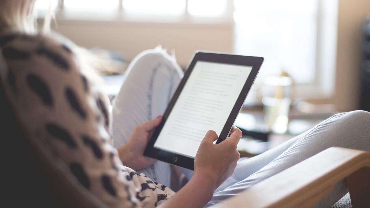 Woman reading About Us page on tablet