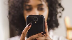 Young woman contacting the Church on her phone
