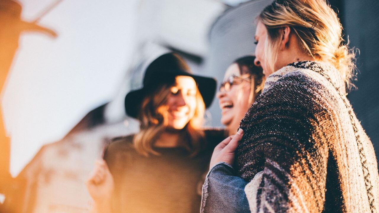 Women visiting church together standing outside
