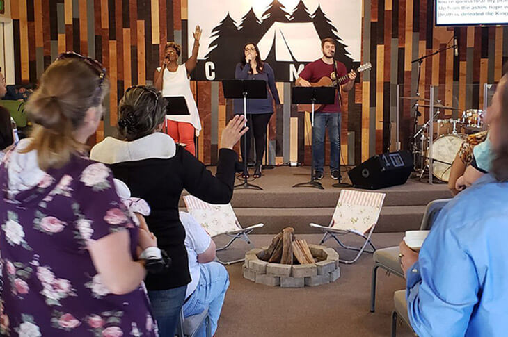 Artistic Church service with congregation signing with hands raised