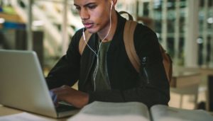 Young man with headphones studying